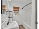 Bathroom featuring shower and tub combo, a new toilet, and laminate floors at 827 Sikes Blvd, Lakeland, FL 33815