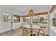 Bright dining area with wood flooring, a charming pendant light, and scenic water view at 827 Sikes Blvd, Lakeland, FL 33815