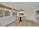 Bright dining area with wood flooring, a charming pendant light, and scenic water view at 827 Sikes Blvd, Lakeland, FL 33815