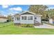 Charming single-story home featuring a cozy front porch and a well-manicured front lawn at 827 Sikes Blvd, Lakeland, FL 33815