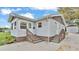 Inviting single-Gathering home featuring a quaint sunroom, updated siding, and a detached garage at 827 Sikes Blvd, Lakeland, FL 33815