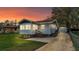 A single-story home with a detached garage, small porch, and a well-maintained lawn at 827 Sikes Blvd, Lakeland, FL 33815