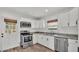 Bright kitchen features stainless steel appliances, white cabinets, and modern countertops at 827 Sikes Blvd, Lakeland, FL 33815