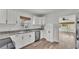 This eat-in kitchen features stainless steel appliances, white cabinets, and luxury vinyl plank flooring at 827 Sikes Blvd, Lakeland, FL 33815