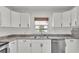 Modern kitchen features white cabinets and stainless steel appliances, and a window view at 827 Sikes Blvd, Lakeland, FL 33815