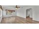 Spacious living room with wood-look floors, ceiling fan, and well-lit windows at 827 Sikes Blvd, Lakeland, FL 33815