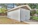 Gray backyard shed with double door and light fixtures at 827 Sikes Blvd, Lakeland, FL 33815