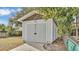 Side view of gray storage shed with double doors in backyard at 827 Sikes Blvd, Lakeland, FL 33815