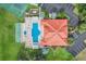 Overhead shot of community pool, shuffleboard, tennis courts, parking and lush landscaping at 8303 Waterview Way # 8303, Winter Haven, FL 33884