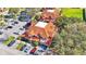 Aerial view of complex with lush landscaping, parking and terra cotta colored rooftops at 8303 Waterview Way # 8303, Winter Haven, FL 33884