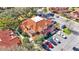 Aerial view of complex with lush landscaping, parking and terra cotta colored rooftops at 8303 Waterview Way # 8303, Winter Haven, FL 33884