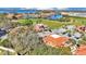 Aerial view of neighborhood homes near a lake with lush landscaping and terra cotta roofs at 8303 Waterview Way # 8303, Winter Haven, FL 33884