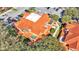 Aerial view of complex with lush landscaping, rooftop patios and terra cotta colored rooftops at 8303 Waterview Way # 8303, Winter Haven, FL 33884
