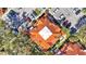 Aerial view of complex with lush landscaping, patios and terra cotta colored rooftops at 8303 Waterview Way # 8303, Winter Haven, FL 33884