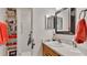 Bathroom vanity area with storage, a large mirror, and a shower with accessibility features at 8303 Waterview Way # 8303, Winter Haven, FL 33884