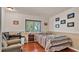 Cozy bedroom with wood floors, a large window, desk, and comfortable armchair at 8303 Waterview Way # 8303, Winter Haven, FL 33884