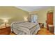 Bedroom features wood floors, a bed, closet space and a sliding glass door with natural light at 8303 Waterview Way # 8303, Winter Haven, FL 33884