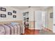 Cozy bedroom with a comfortable bed, laminate wood floor, closet, and neutral two-tone paint at 8303 Waterview Way # 8303, Winter Haven, FL 33884