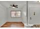 Bright entryway with wood floors, large window, and a white front door at 8303 Waterview Way # 8303, Winter Haven, FL 33884