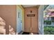 The front porch has a sturdy door to protect the front door, and a convenient broom for keeping the entry neat at 8303 Waterview Way # 8303, Winter Haven, FL 33884