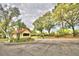 Community gate house with security booth and surrounding lush trees and landscaping at 8303 Waterview Way # 8303, Winter Haven, FL 33884