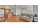 Open-concept living room showcasing hardwood floors, an island with stone countertops, and a ceiling fan at 8303 Waterview Way # 8303, Winter Haven, FL 33884