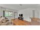 Open living room featuring a large window with a view, hardwood floors, and modern decor at 8303 Waterview Way # 8303, Winter Haven, FL 33884