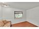 Bright living room featuring wood floors and a window overlooking the outdoor landscape at 8303 Waterview Way # 8303, Winter Haven, FL 33884