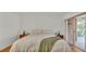 Bright bedroom with neutral tones, wood floors, and a sliding glass door leading to the outside at 8303 Waterview Way # 8303, Winter Haven, FL 33884