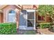 Enclosed outdoor patio with screen, overlooking yard with plants and mulch at 8303 Waterview Way # 8303, Winter Haven, FL 33884