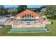 Aerial view of the community pool, shuffleboard, and sun deck with ample seating for residents at 8303 Waterview Way # 8303, Winter Haven, FL 33884