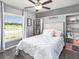 Bedroom featuring a decorative accent wall, light grey carpet, and a comfortable bed with a white comforter at 1001 Aruba Ave, Mulberry, FL 33860