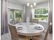 Bright dining room featuring a modern light fixture, stylishly decorated round table, and a sliding door to the outside at 1001 Aruba Ave, Mulberry, FL 33860