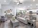 Living room with an open layout, featuring wood floors, a comfy sofa, and access to the kitchen at 1001 Aruba Ave, Mulberry, FL 33860