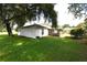 Picture of a large backyard, featuring a screened patio, with a spacious lawn and mature trees at 1065 Jordan Rd, Lakeland, FL 33811