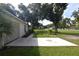 View of concrete patio, lawn, and garden areas at 1065 Jordan Rd, Lakeland, FL 33811