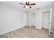 Bedroom with a ceiling fan, light gray walls, wood flooring and closets at 1065 Jordan Rd, Lakeland, FL 33811