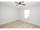 Bedroom featuring a ceiling fan, light gray walls, wood flooring and windows at 1065 Jordan Rd, Lakeland, FL 33811