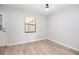 Bedroom with a large window, light wood floors, and neutral paint at 1065 Jordan Rd, Lakeland, FL 33811