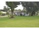 Charming home with well-maintained lawn and mature trees that enhance the property's curb appeal at 1065 Jordan Rd, Lakeland, FL 33811