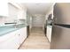 Galley kitchen with stainless steel appliances, white cabinets and wood-look floors at 1065 Jordan Rd, Lakeland, FL 33811