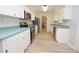 Bright kitchen featuring stainless appliances, light wood floors, and white cabinetry at 1065 Jordan Rd, Lakeland, FL 33811