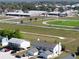 Aerial view of a light colored house near a school and large athletic field in a residential area at 1100 Lowry Ave # 51, Lakeland, FL 33801