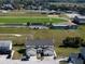 Aerial view of home next to athletic field with clear blue skies above the neighborhood at 1100 Lowry Ave # 51, Lakeland, FL 33801