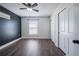 Bedroom with dark accent wall, new floors, window, ceiling fan, and closet at 1100 Lowry Ave # 51, Lakeland, FL 33801