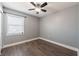 Bedroom with grey walls and new floors; large window letting in lots of light at 1100 Lowry Ave # 51, Lakeland, FL 33801