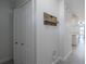 Hallway with coat closet and decorative storage, leading to tiled floors at 1100 Lowry Ave # 51, Lakeland, FL 33801