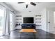 Bright living room featuring dark floors, sliding glass doors, and built-in shelving at 1100 Lowry Ave # 51, Lakeland, FL 33801