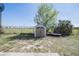 Backyard features a storage shed and tree, surrounded by a chain-link fence, offering practical outdoor space at 1100 Lowry Ave # 51, Lakeland, FL 33801