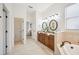 This bathroom features a double sink vanity and a soaking tub at 1108 Stoney Creek Blvd, Lakeland, FL 33811